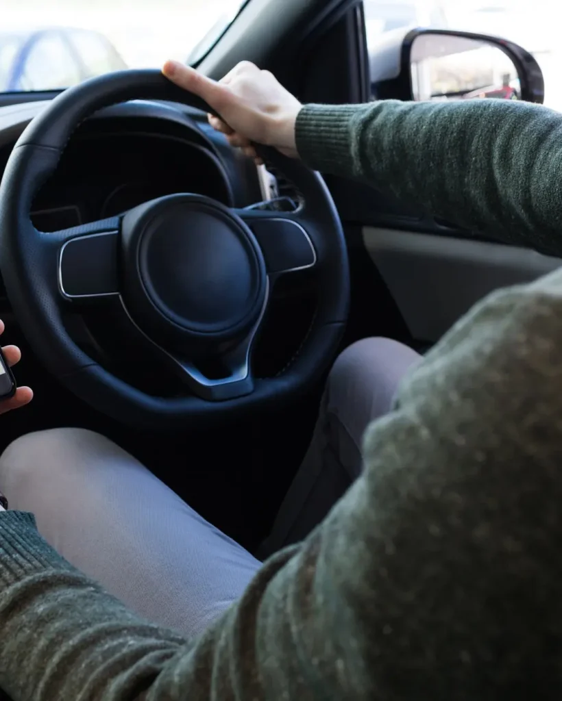 man-using-smartphone-while-driving-car